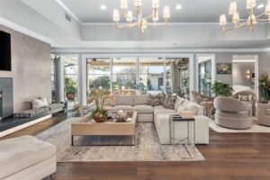 Feb real – 1401 Westover Lane – the sunken living room with modern lighting and stone fireplace surround. (Courtesy photo)