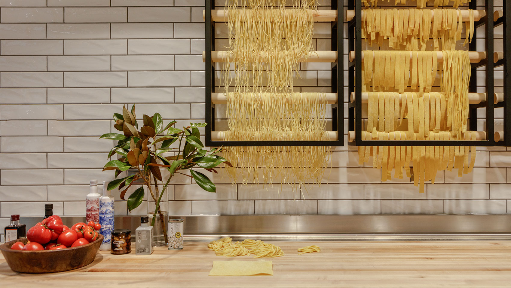 Italian – the pasta station inside il Modo displays the freshly made pasta drying on wooden racks.