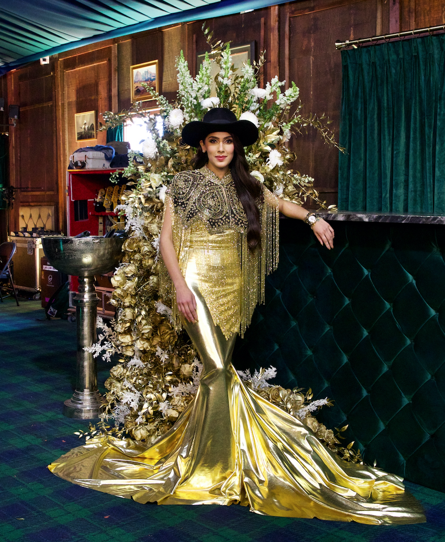 Zinat Ahmed saluting the 50th golden anniversary of the World's Championship Bar-B-Que Contest in a gilded gown at the Cotton 'Q Club. (Photo courtesy of Cotton Holdings Inc.)
