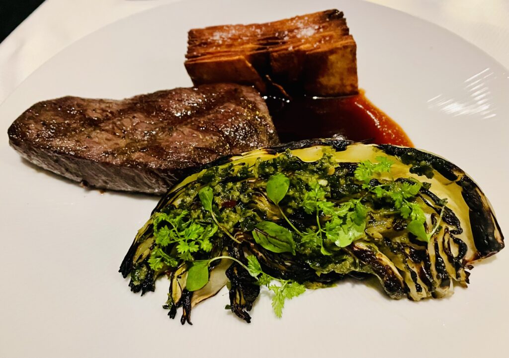 Denver cut steak sided by potato pavet and grilled cabbage. (Photo by Courtney Dabney)