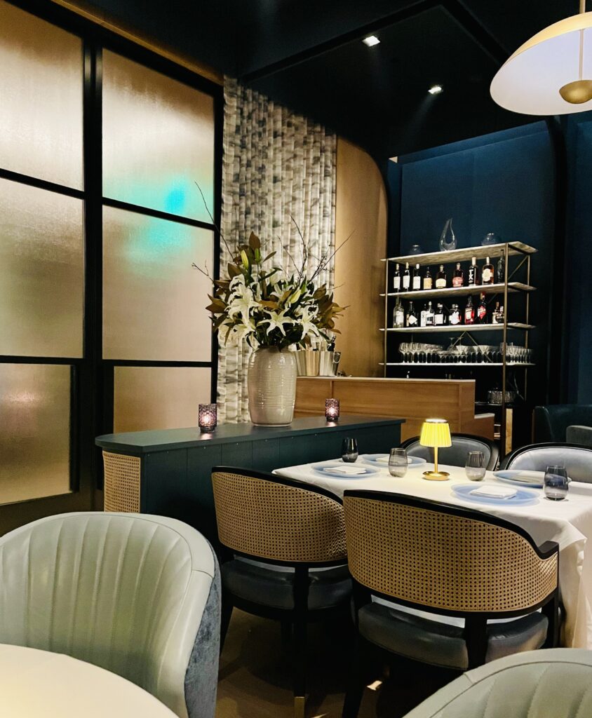 The Blue Room at Emilia's is hidden behind frosted glass doors, with its own private bar. (Photo by Courtney Dabney)