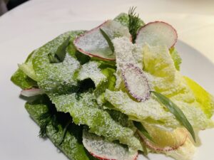 The Blue Room – The simplicity of a butter lettuce salad with grated goat cheese and fresh herbs. (Photo by Courtney Dabney)