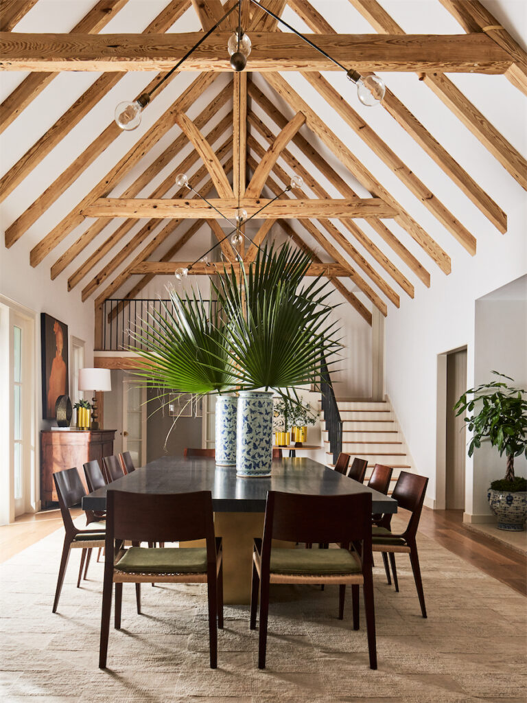Architect Charles Dilbeck originally designed the split-level space as a living area with bedrooms upstairs. It’s now a dining room, with custom table by Philip Thomas Vanderford and McGuire chairs. (Photo by Stephen Karlisch)
