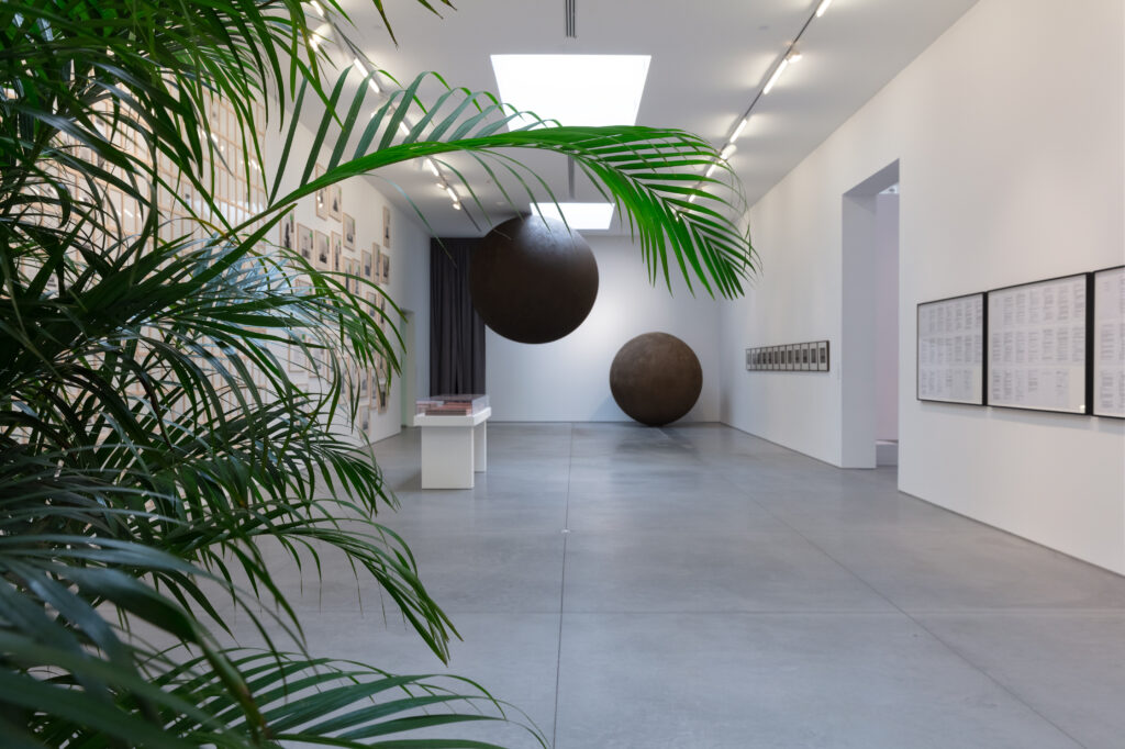 "For What It’s Worth: Value Systems in Art since 1960," The Warehouse, Dallas, installation view with work by Marcel Broodthaers (foreground); Hanne Darboven, Yukinori Yanagi, Felix Gonzalez-Torres, and Cameron Rowland (background), on view through June 29, 2024 (Photo by Kevin Todora)