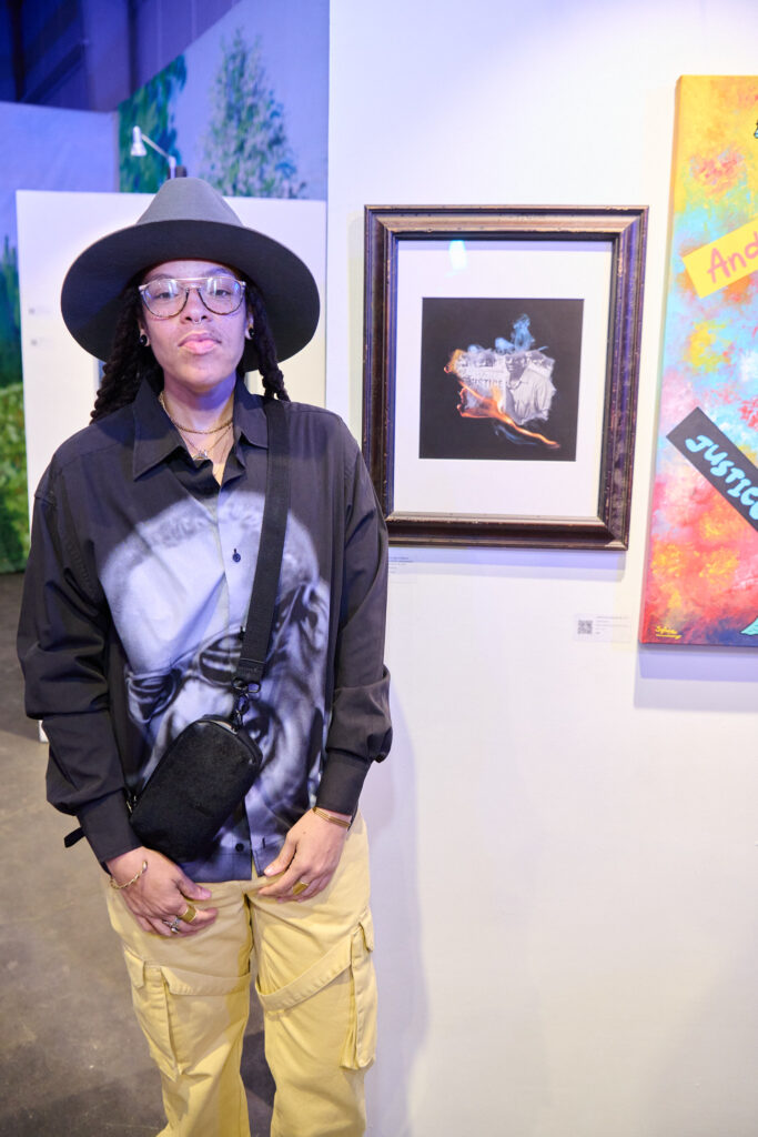 Arnea Williams with their artwork at Fresh Arts Wonder Ball (Photo by Charlie Horse Photography)