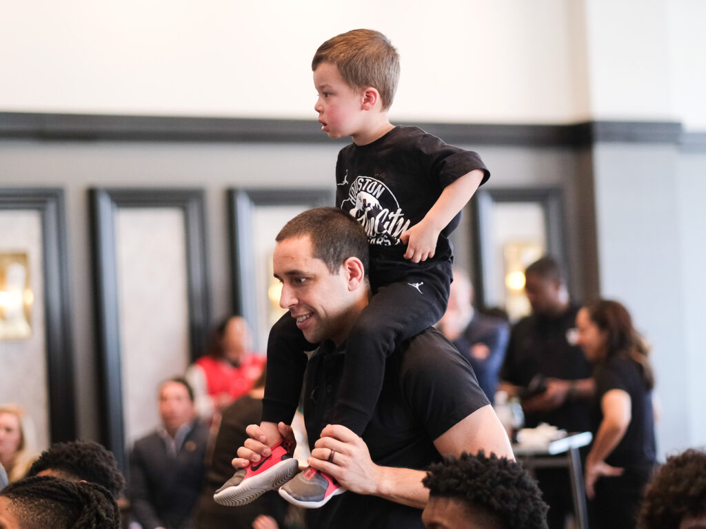 University of Houston assistant coach Kellen Sampson turned Selection Sunday into a family day, giving his son Kylen a ride. (Photo by F. Carter Smith)