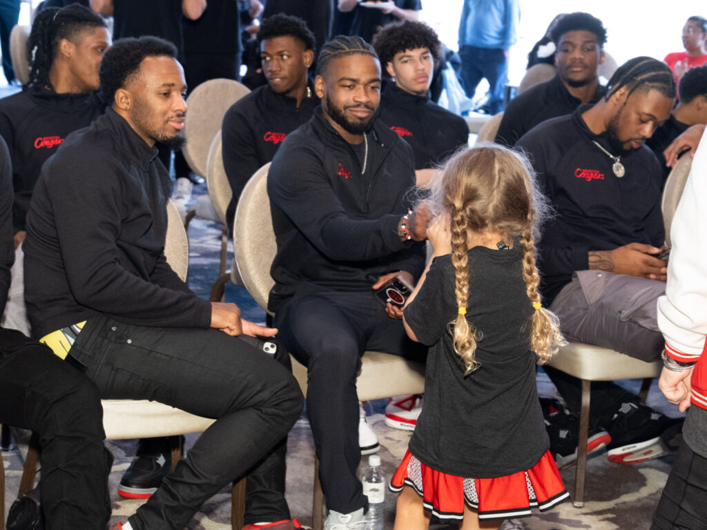 Five-year-old Maisy Jade Sampson is already connecting with the UH players. (Photo by F. Carter Smith)