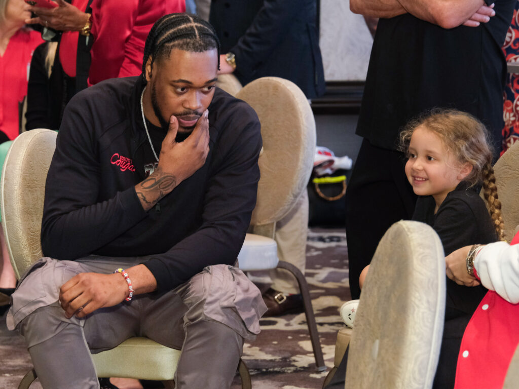 University of Houston power forward J'Wan Roberts spent time with his biggest fan — Kelvin Sampson's granddaughter Maisy Jade — at UH's Selection Sunday party. (Photo by F. Carter Smith)