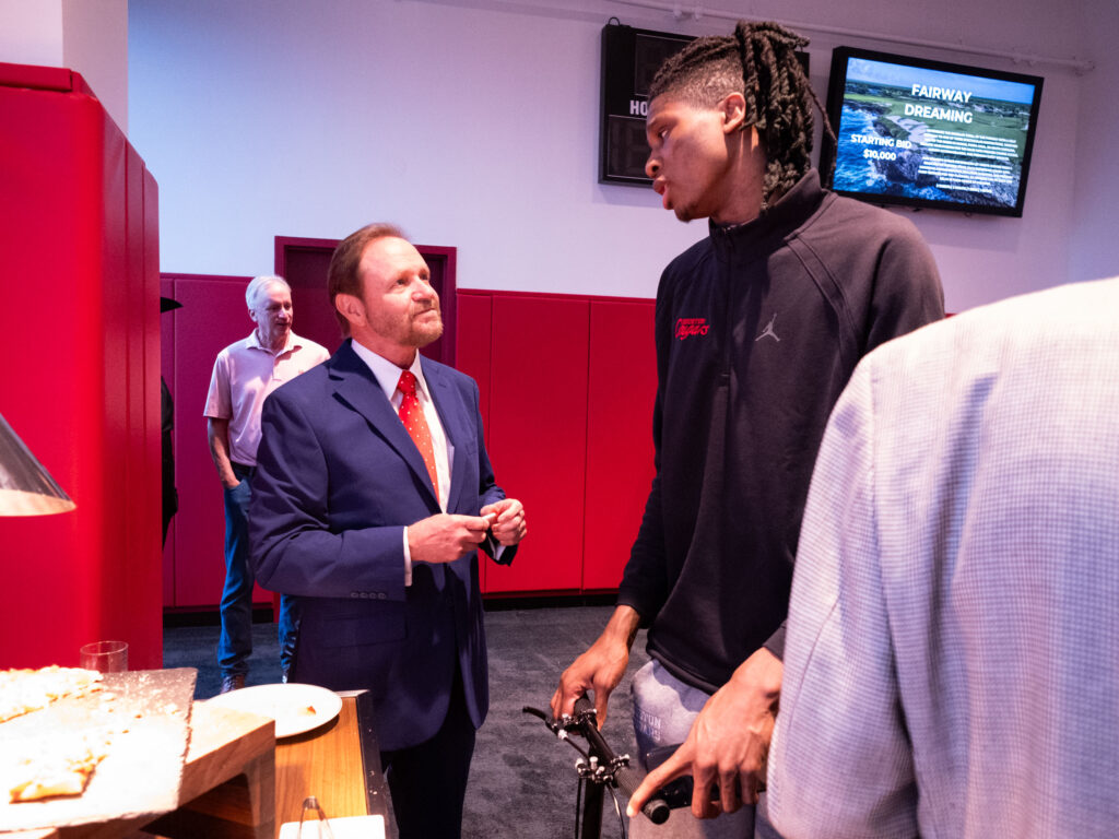 Injured Houston freshman JoJo Tugler wheels around everywhere on his little scooter, helping to heal the broken bone in his foot. (Photo by F. Carter Smith)