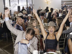 Jay & Allie Fields bidding during the Sky High for Kids 'Better in Boots' (Photo by Quy Tran Photography)