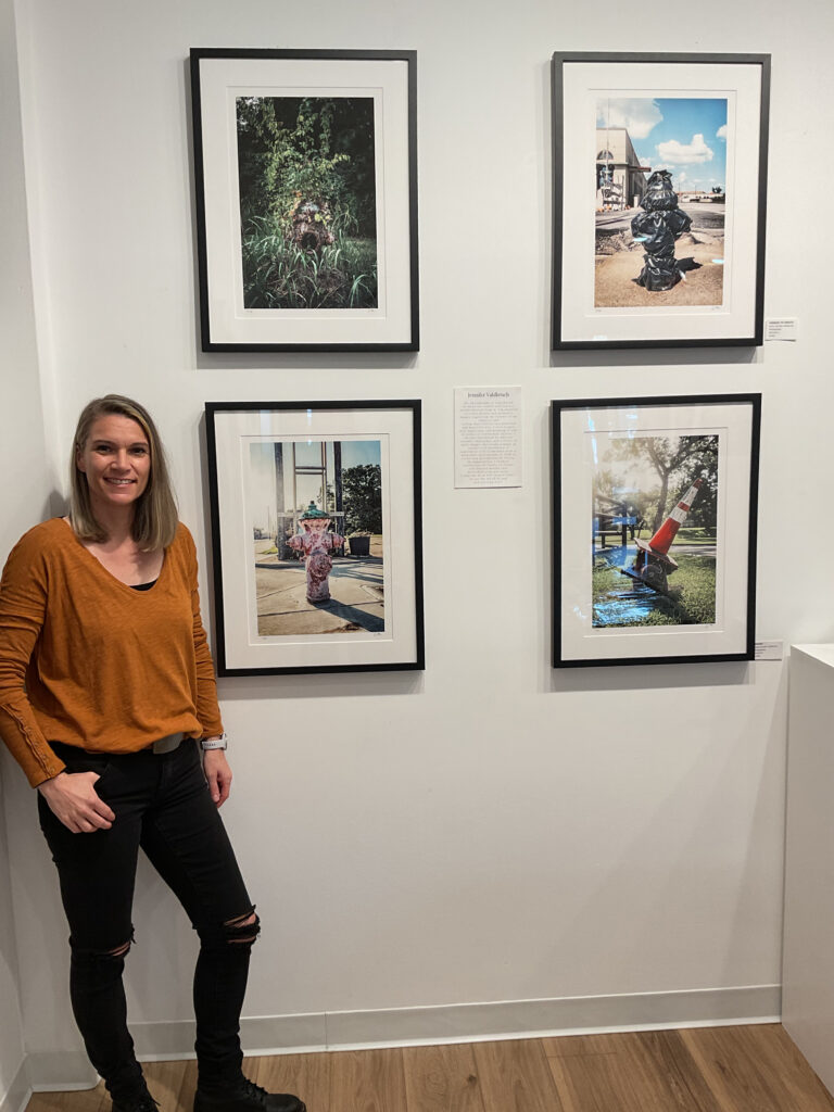 Artist Jennifer stikes a pose at the Ardest Gallery with her photo series "Hydrants."