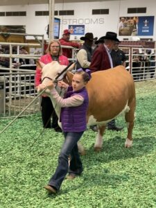 A youngster with her charge at the 2023 Junior Market Steer Auction at RodeoHouston