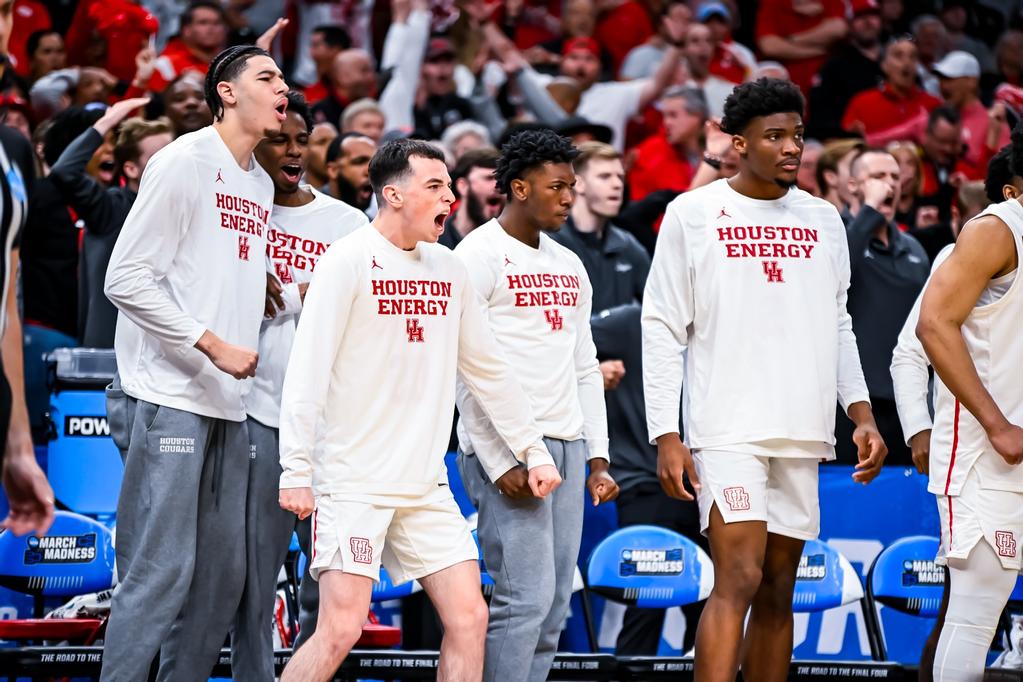 Ryan Elvin (second from left) cheered Houston on early and then found himself helping send UH to the Sweet 16 in a wild overtime win over Texas A&M. (Photo by Matthew A. Smith, courtesy UH athletics).