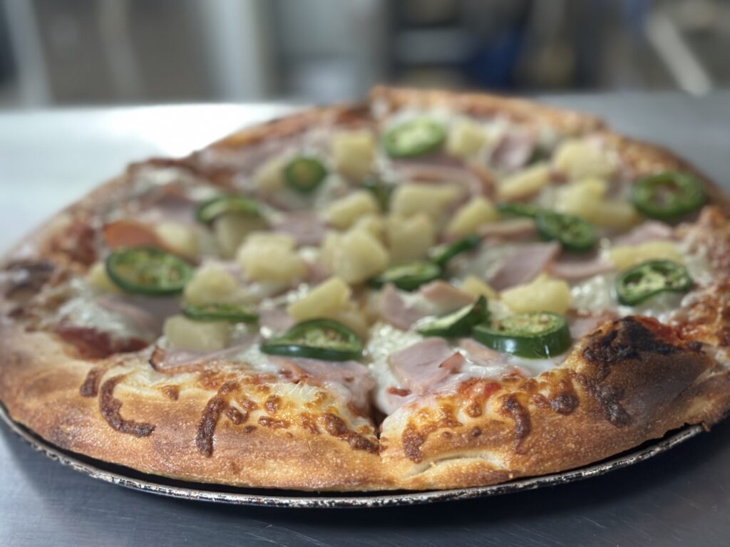 Pizza – The Hawaiian pizza with Canadian bacon, pineapple and jalapeno at Buffalo Bros.