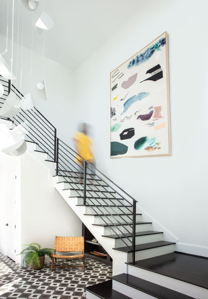 Large, bold artwork is framed in the open stairway of this bold redesign of a house in Woodson's Reserve. (Photo by Kerry Kirk)