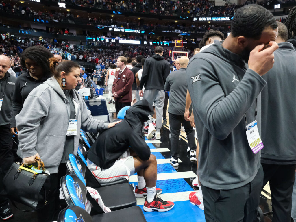 UH director of basketball operations Lauren Sampson tried to make injured point guard Jamal Shead feel a little better. (Photo by F. Carter Smith)