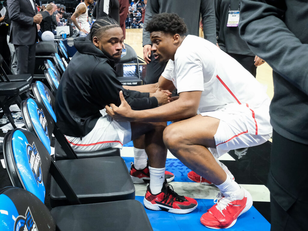 Cedric Lath tried to console Houston point guard Jamal Shead after the NCAA Tournament loss. (Photo by F. Carter Smith)