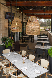 The outdoor patio at Costa Fina has a special table in the corner, amid outdoor plants in an area screened from the parking lot.