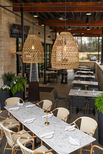 The outdoor patio at Costa Fina has a special table in the corner, amid outdoor plants in an area screened from the parking lot.