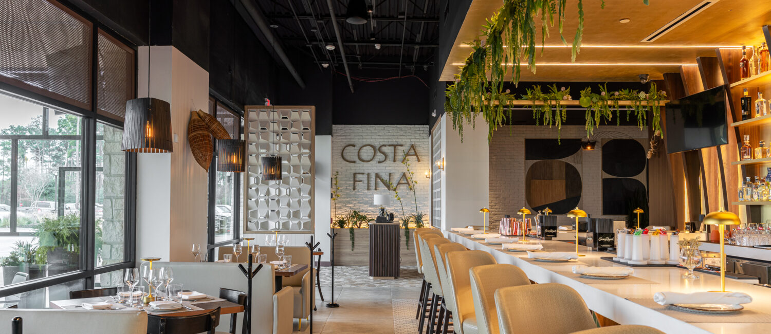 The bar at Costa Fina has tables and bar area seating among tropical plants. They both overlook the patio.