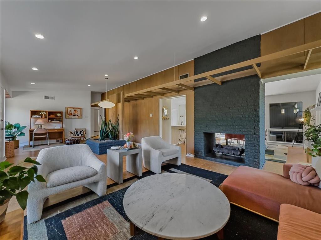 A double-sided fireplace is a centerpiece in the mid-century modern home. 