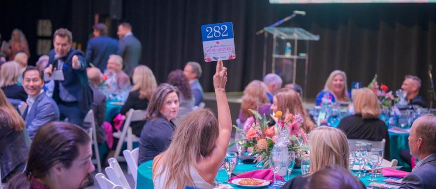 Auctioneer Pat Tully took the crowd through spirited bidding on a number special items, including trips and dinner.