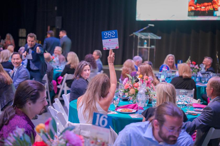 Auctioneer Pat Tully took the crowd through spirited bidding on a number special items, including trips and dinner.