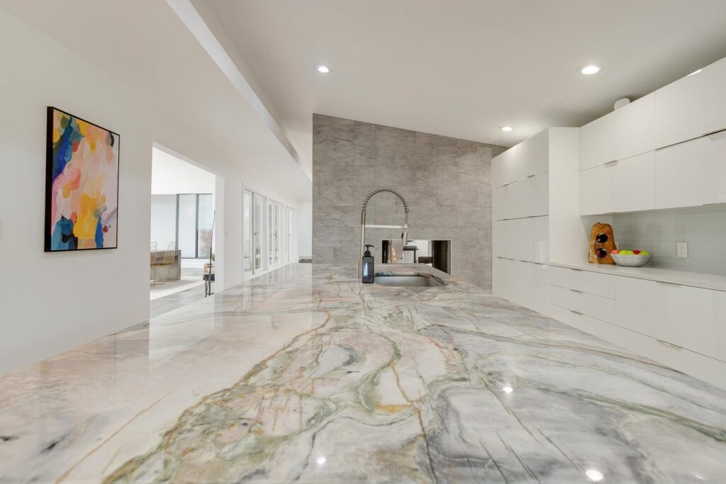 The kitchen features stunning quartzite counters and a waterfall island.