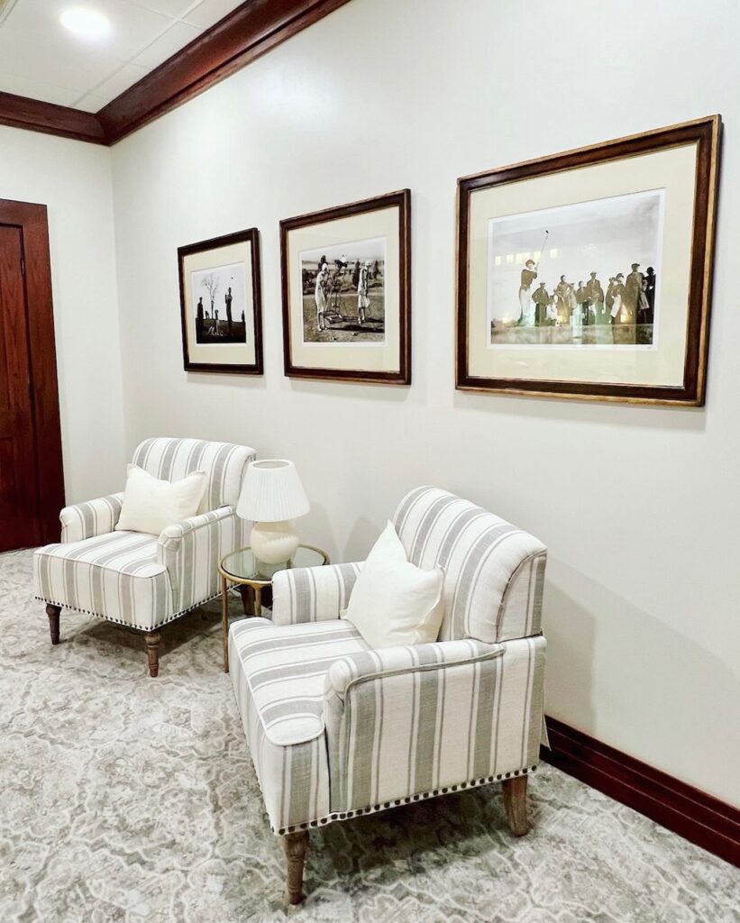 (After) The vintage golf photos are now at the entrance to the Ladies' Lounge.