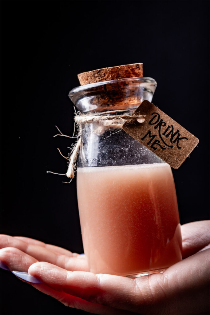 The Drink Me at Apothecary includes  pineapple juice, cherry juice, vodka, pineapple amaro, glitter, and graham cracker tincture. (Photo by Samantha Marie)