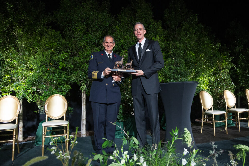 Fire chief Palmer Buck accepted the Mitchell Award on behalf of the Woodlands firefighters from Howard Hughes president of Houston region Jim Carmen.