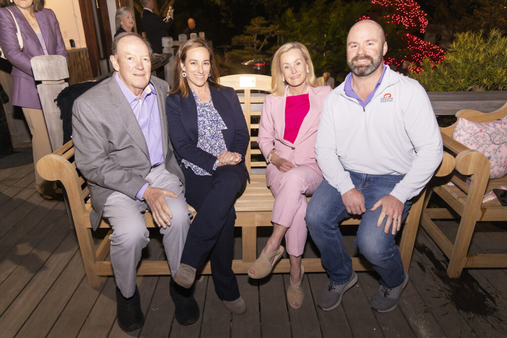 Bill Landreth, Anjie Butler, Gail Landreth, and William Butler cozy up on a bench at Evening in the Garden. (Photo by Sharon Ellman)