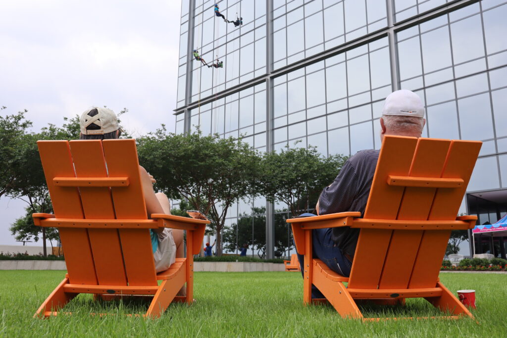 Dora and David Lipper (chairs) celebrate Dena Wren Mumford (left rope) and McKensie Wren East (rIght rope) coming down the building during the Camp for All fundraiser.