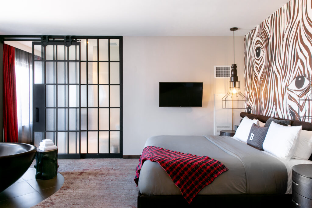 Guest rooms and suites at Bobby Nashville are decorated eclectically with inkblot carpeting and various artwork. (Photo by Lisa Diederich Photography)