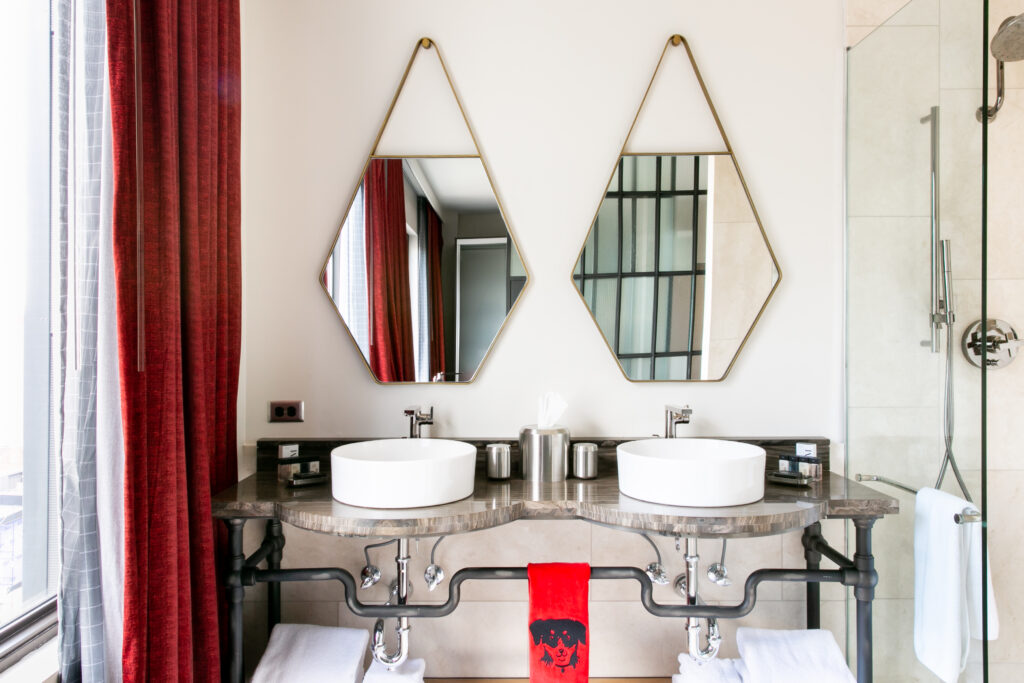 Each bathroom at Bobby Nashville features glass pane walls and William Roam bath products. (Photo by Lisa Diederich Photography)
