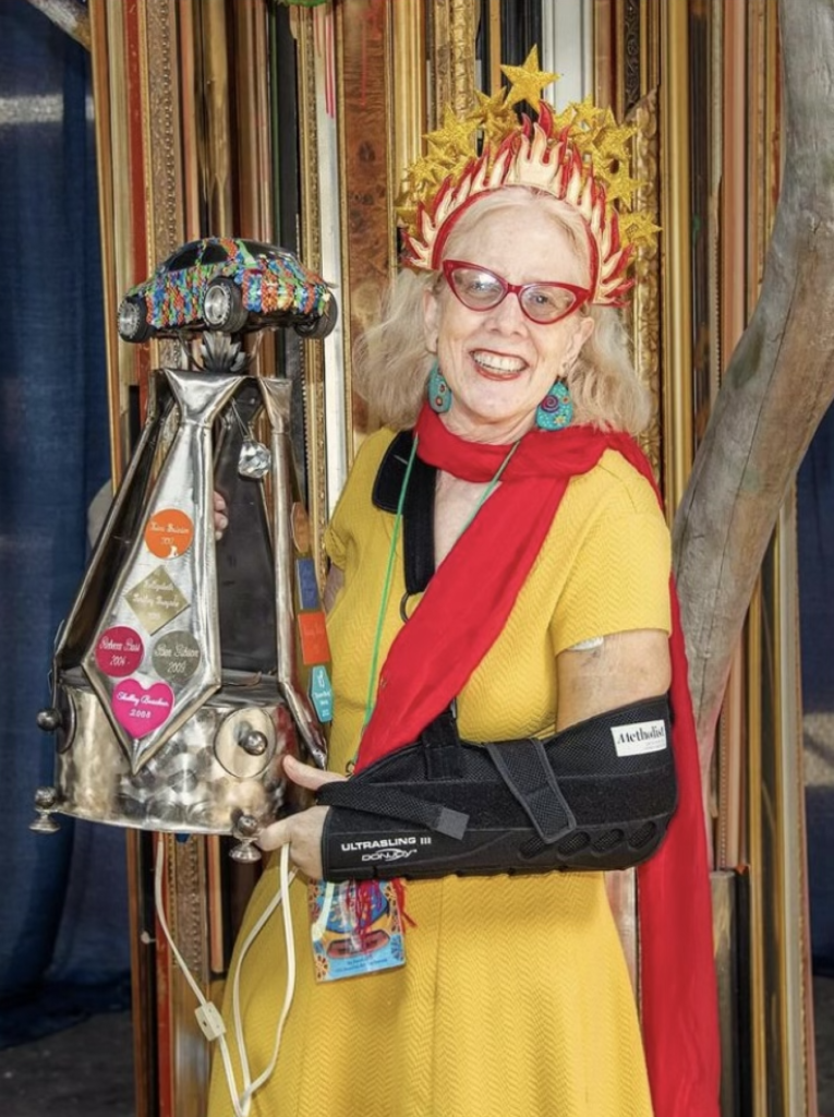 Sarah Gish with Houston Art Car Klub's "Brother BrianBryan" award for Iggy the Igniter, 2024 
