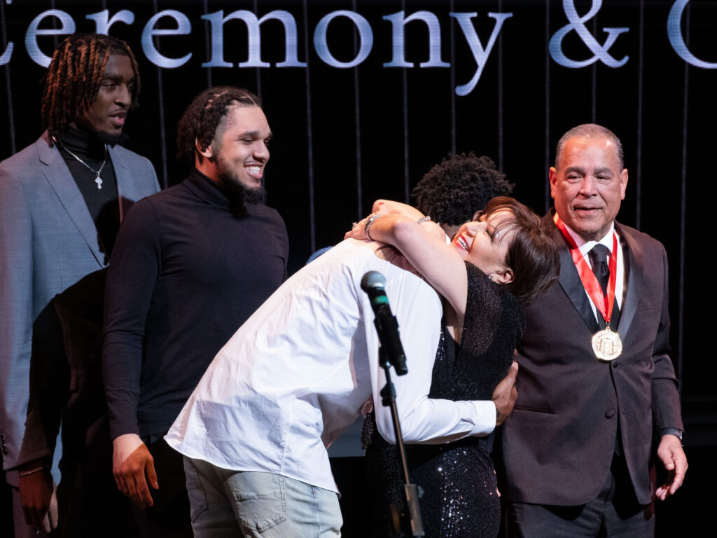 University of Houston forward Terrance Arceneaux gets a big hug from Karen Sampson as Ja’Vier Francis, Emanuel Sharp and Kelvin Sampson look on. (Photo by F. Carter Smith)