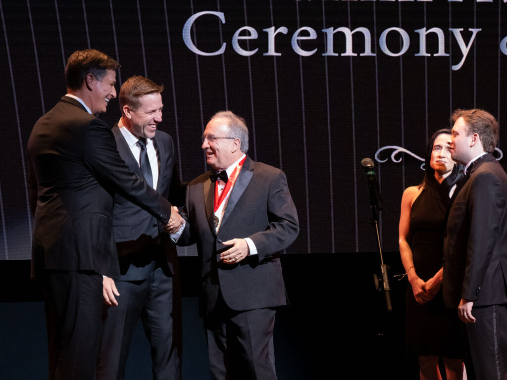 Reid Gettys and Case Keenum share a moment with Mark Berman at UH Alumni Awards. (Photo by F. Carter Smith)
