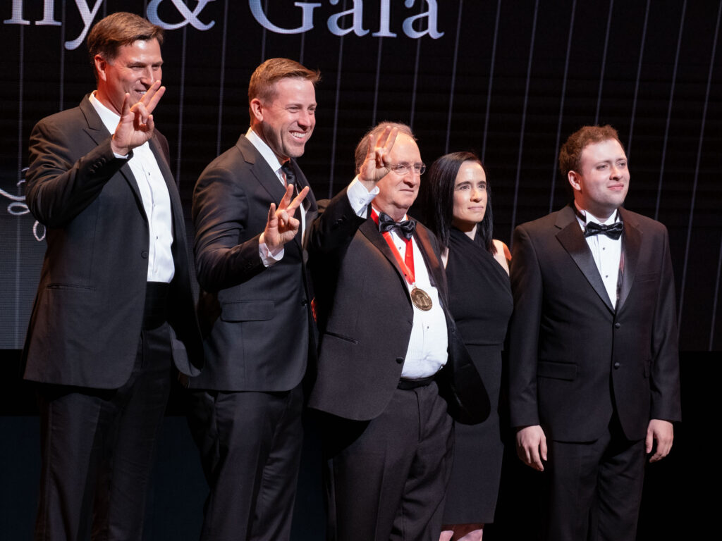 Reid Gettys, Case Keenum, Mark Berman, Jessica Berman, and Jacob Berman enjoy Berman's Distinguished Alumni Award moment. (Photo by F. Carter Smith)