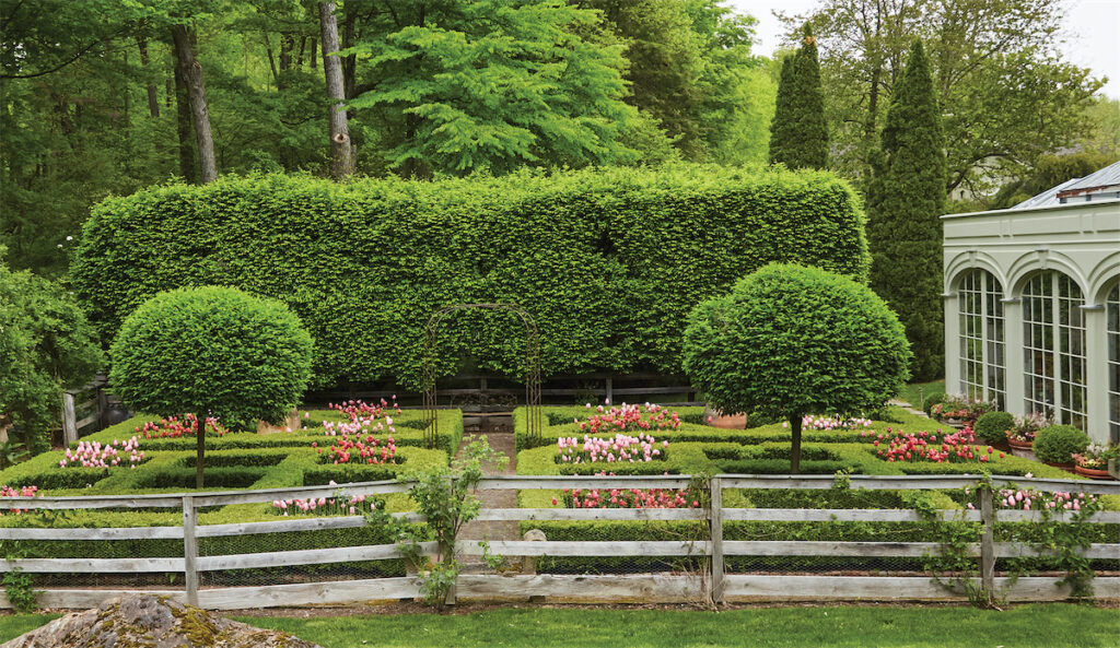 The parterre was inspired by a design by English gardener Rosemary Verey. The conservatory, at right. (Photo by Annie Schlechter)