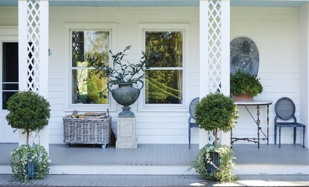 A porch with vintage and antique garden
ornaments and furniture. (Photo by Annie Schlechter)