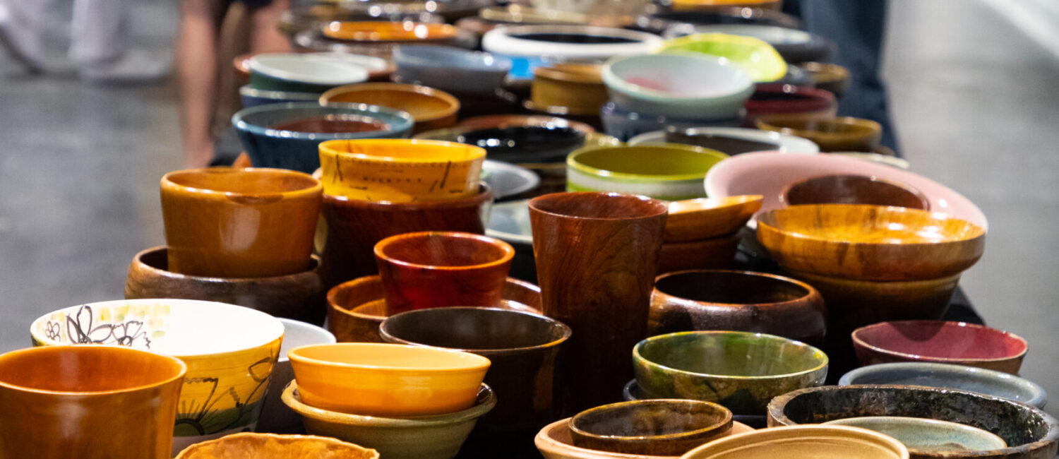 This table is covered in unique Empty Bowls art pieces. (Courtesy Empty Bowls Houston)