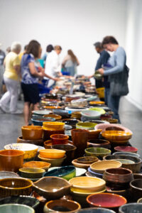 This table is covered in unique Empty Bowls art pieces. (Courtesy Empty Bowls Houston)