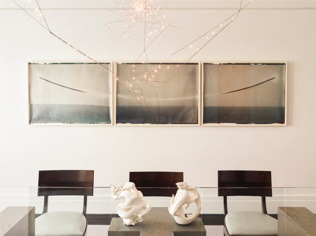 Kaj Gottlob vintage Danish dining chairs in Jerry Pair leather. Custom light fixture, Bastien Carré. Chris McCaw triptych. On table, vintage Sèvres porcelain sculptures. (Photo by Eric Piasecki)