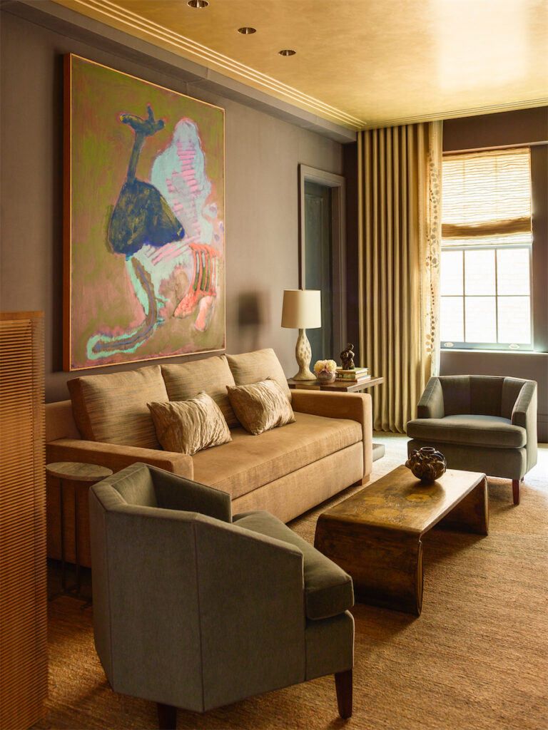 Library walls and molding are upholstered in Gretchen Bellinger wool felt. Vintage Max Kuehne coffee table. Vintage club chairs in alpaca velvet. Custom sofa in Manuel Canovas linen. Rose Tarlow pillows. John Altoon painting. Custom rug by Tai Ping Carpets. (Photo by Eric Piasecki)