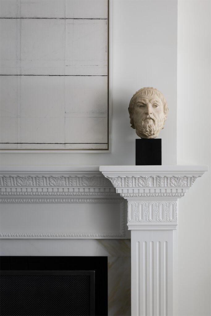 The living room’s original carved fireplace was restored. Greek Revival 1950s stone bust acquired on 1stdibs. Hélèn Durdilly 2017 artwork from Amelie, Maison d’Art, Paris. (Photo by Trevor Parker)