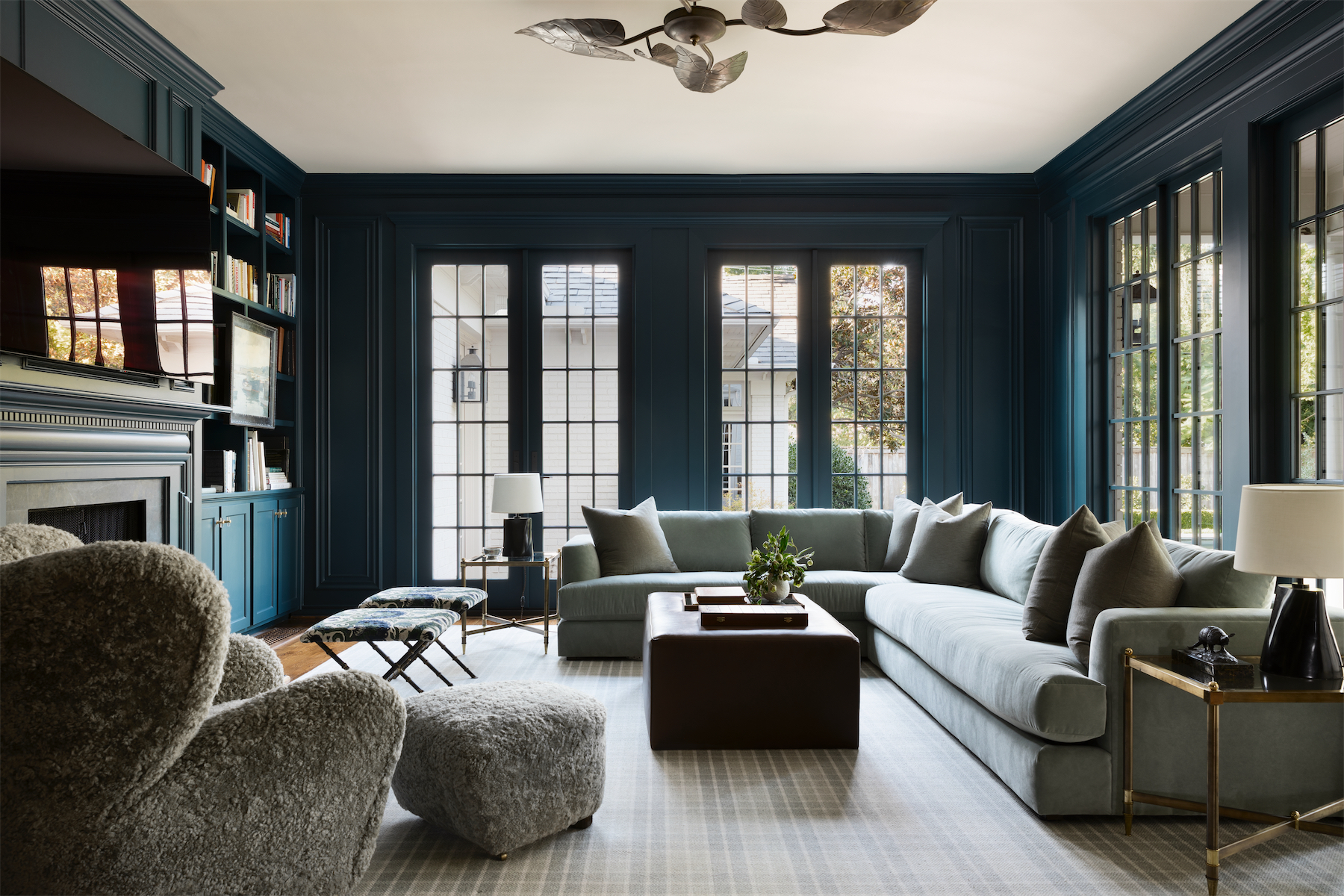 Fort worth home tour - a library-style living room painted dark blue