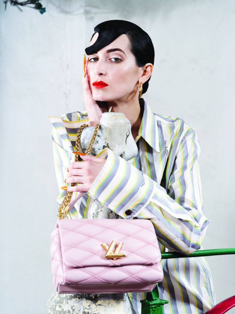 Louis Vuitton multi-stripe silk shirt $2,270, G0-14 MM handbag $6,750, and Louise hoop GM earrings $715. 