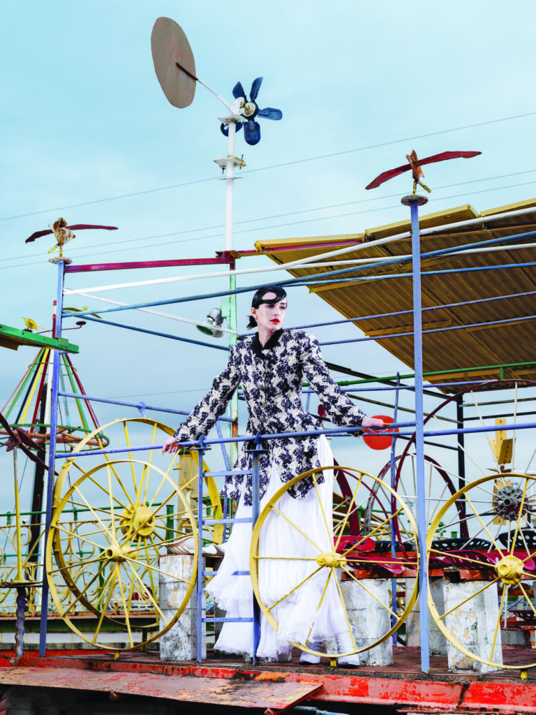 Louis Vuitton double-stripe draped blouse $3,650, mixed-stripe tiered skirt $6,200, and LV Knot pump $1,360. 