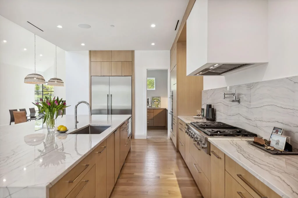 Santorini white quartzite tops the kitchen counters and waterfall island.